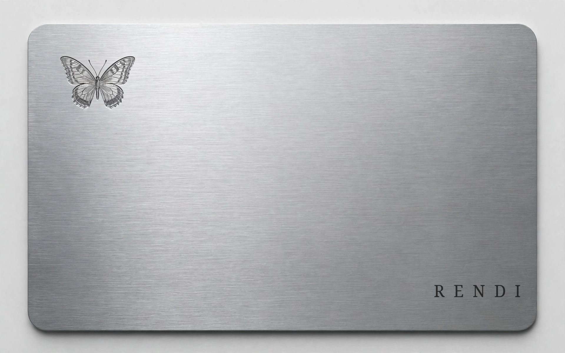 The Rendi Collector Card in brushed metal, with a small engraved butterfly and the Rendi wordmark.